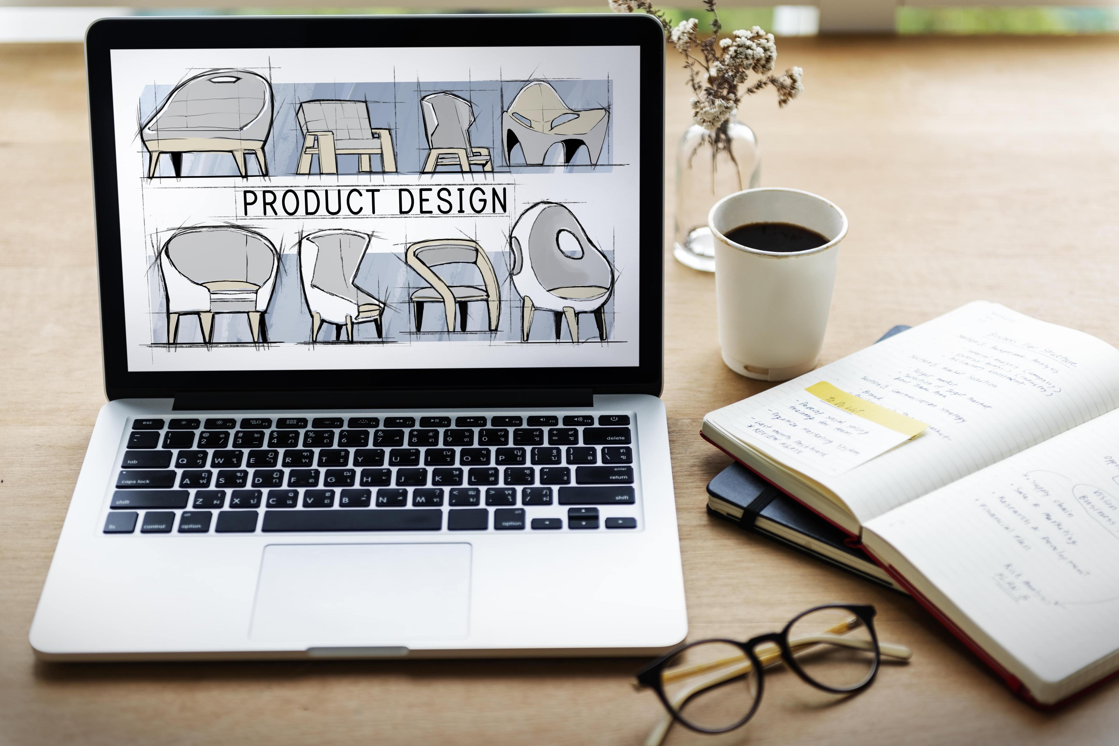 Product design on the screen of a laptop, glasses, and a cup of coffee on a table